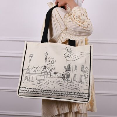 tote bag the dream is still going with phone pocket suitable for college, school or lifestyle bag, made form cotton canvas with black handle and Arabic printing